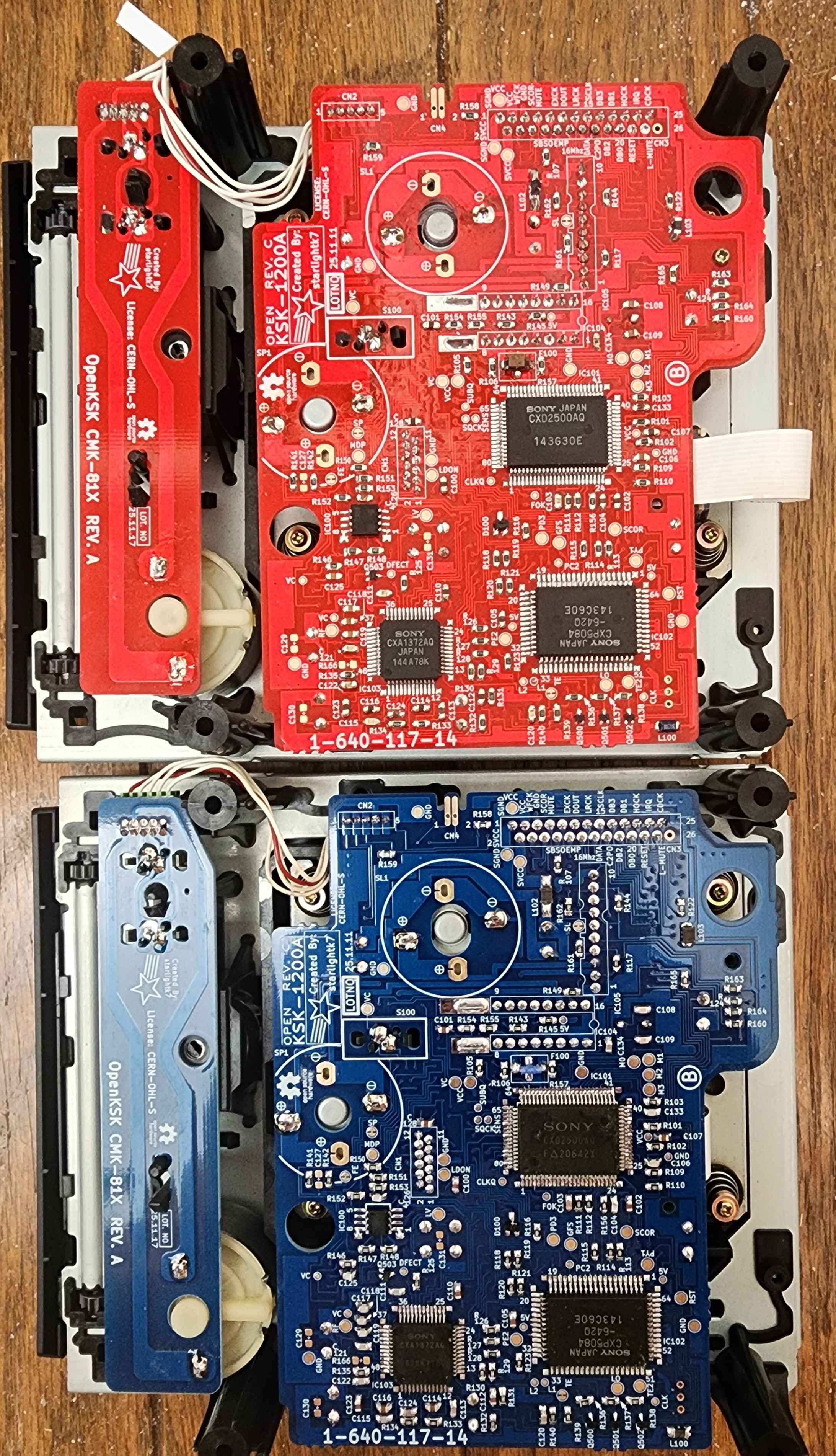 Red and blue OpenKSK KSK-1200A production boards side by side.